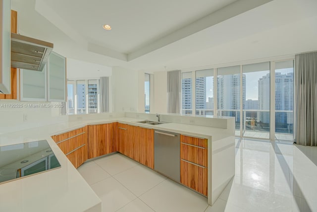 kitchen featuring black electric cooktop, light countertops, dishwasher, a peninsula, and light tile patterned flooring