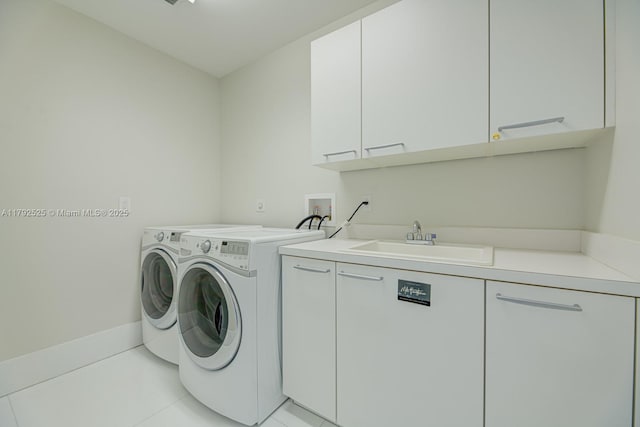 laundry area featuring cabinet space, independent washer and dryer, and a sink