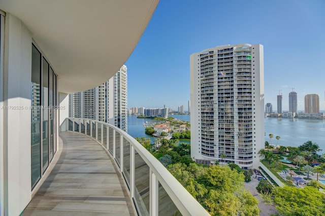 balcony with a view of city and a water view