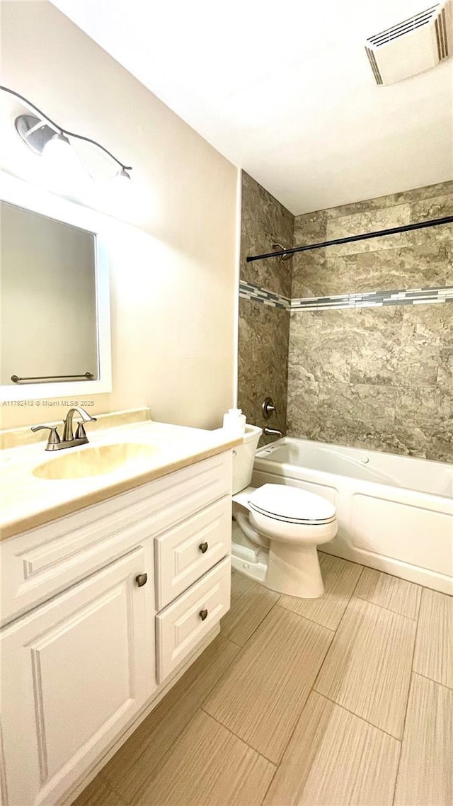 bathroom with visible vents, shower / bath combination, toilet, and vanity