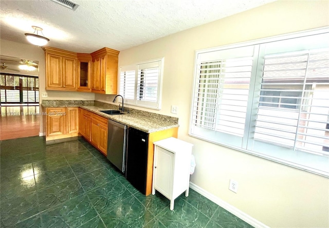 kitchen featuring a textured ceiling, visible vents, brown cabinets, dishwasher, and a sink
