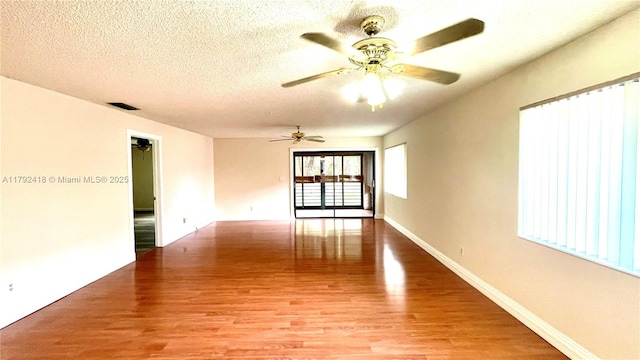 unfurnished room with visible vents, baseboards, ceiling fan, a textured ceiling, and light wood finished floors