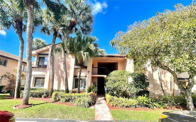 2141 SW 93rd Way Unit 704, Davie, FL 33324 - view of front of home with stucco siding, a balcony, and a front yard
