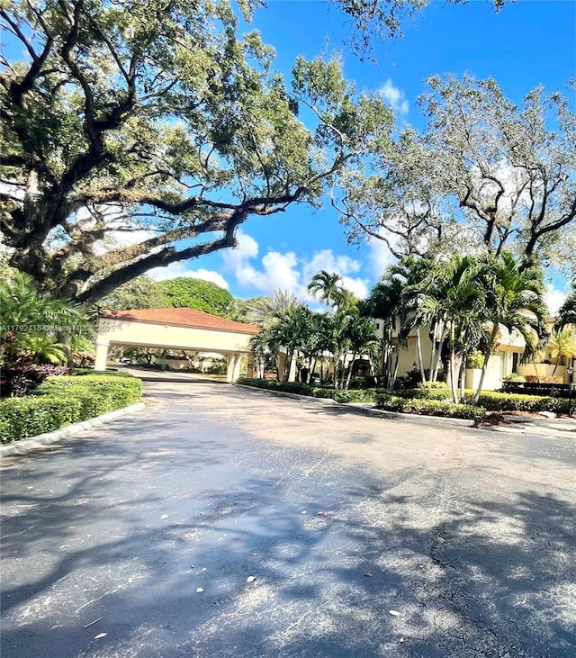 2141 SW 93rd Way Unit 704, Davie, FL 33324 - view of asphalt road featuring curbs