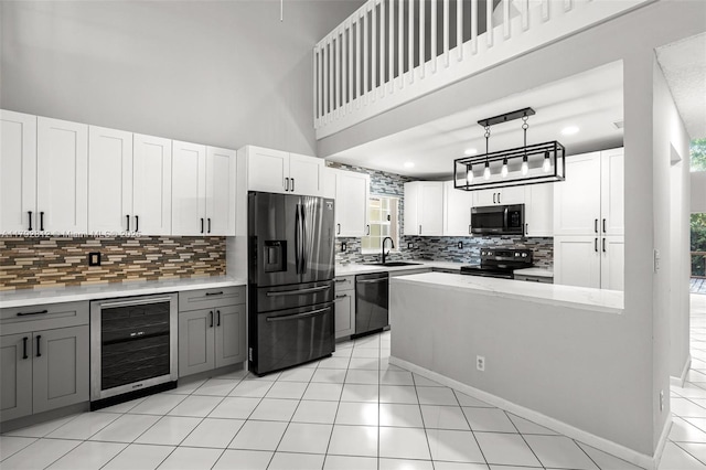kitchen with beverage cooler, gray cabinets, fridge with ice dispenser, range with electric stovetop, and dishwashing machine