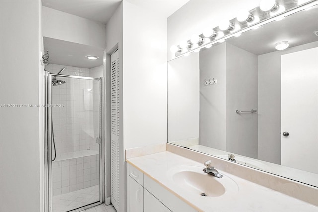 bathroom featuring a shower stall and vanity