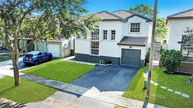 view of front of property with an attached garage, stucco siding, driveway, and a tile roof
