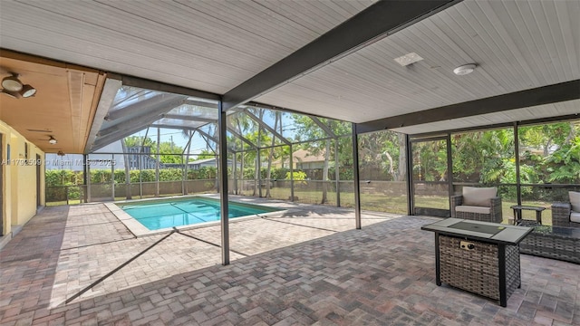 view of swimming pool with a fenced in pool, a patio, and a lanai