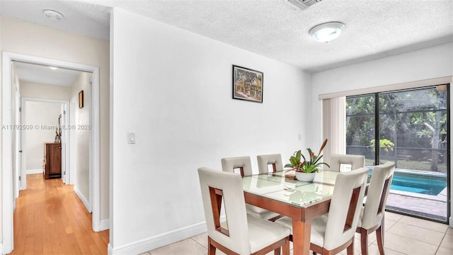 19241 SW 93rd Rd, Cutler Bay, FL 33157 - dining space with a textured ceiling and baseboards