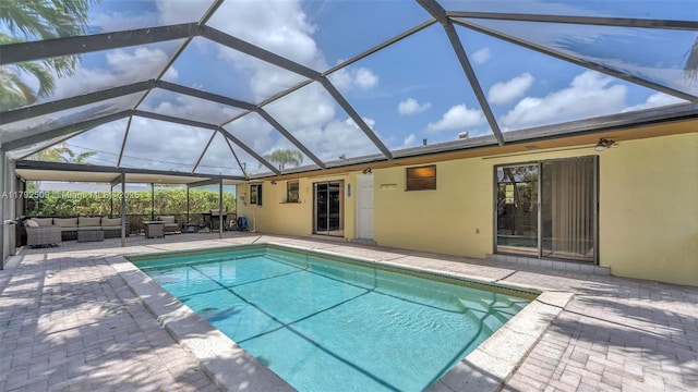 outdoor pool featuring outdoor lounge area, a lanai, and a patio area