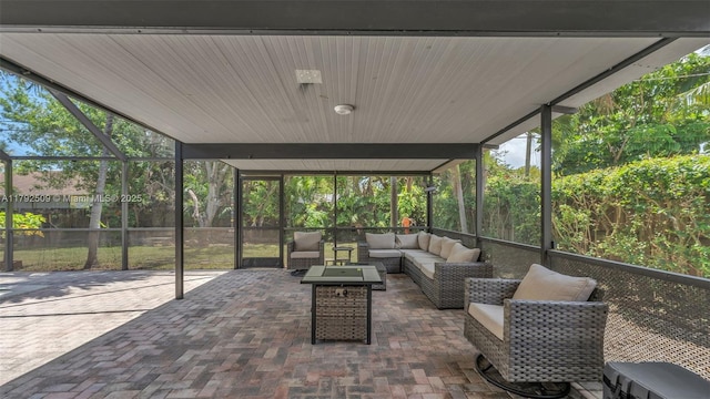 view of patio / terrace featuring a lanai and an outdoor living space