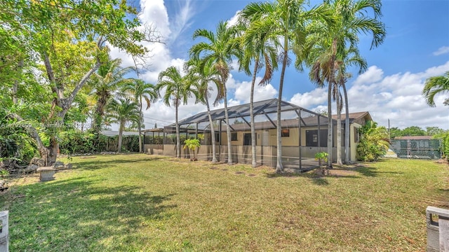 view of yard with a fenced backyard and a lanai