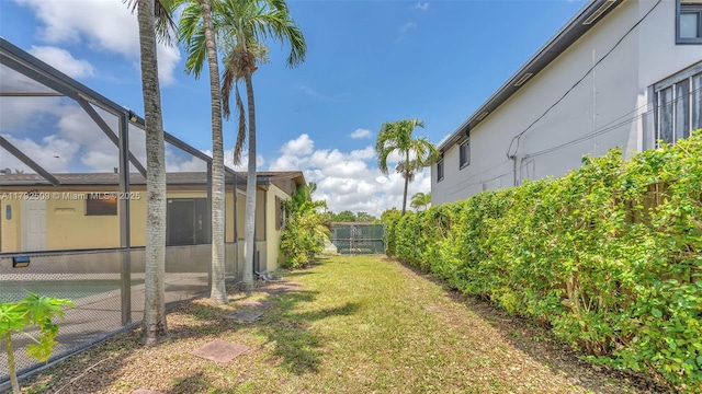 view of yard featuring fence and a lanai