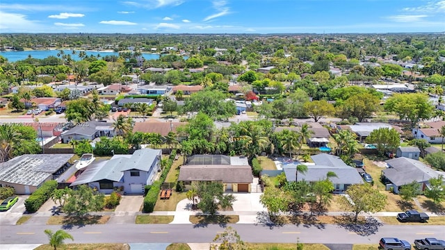 drone / aerial view with a water view and a residential view