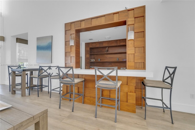 dining space featuring baseboards and wood finished floors