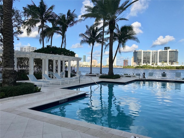 community pool featuring a patio, a water view, and a pergola