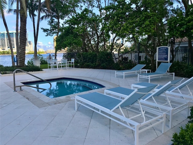 view of pool featuring a patio and fence