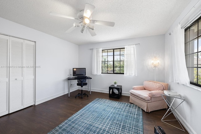 sitting room with baseboards, a textured ceiling, ceiling fan, and wood finished floors