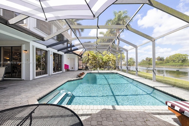 pool with a water view and a patio area