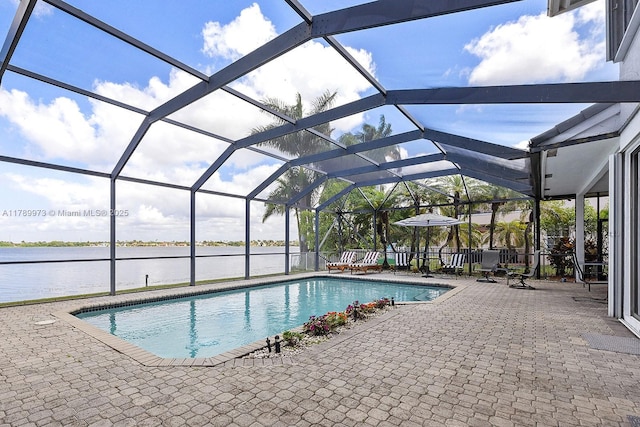outdoor pool with a patio, a water view, and a lanai