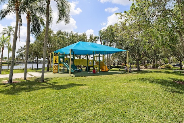 community playground with a water view and a yard