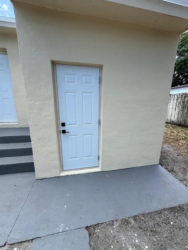 doorway to property with stucco siding