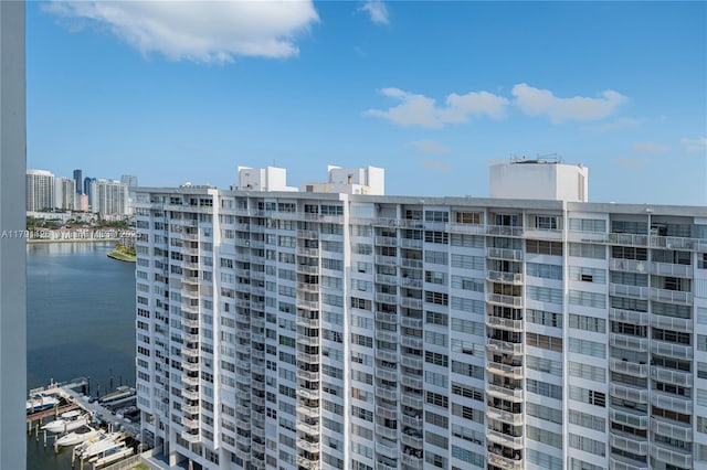 view of building exterior with a city view and a water view