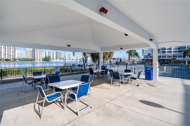 view of patio / terrace with a water view and fence