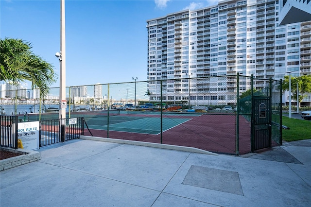 view of sport court featuring fence