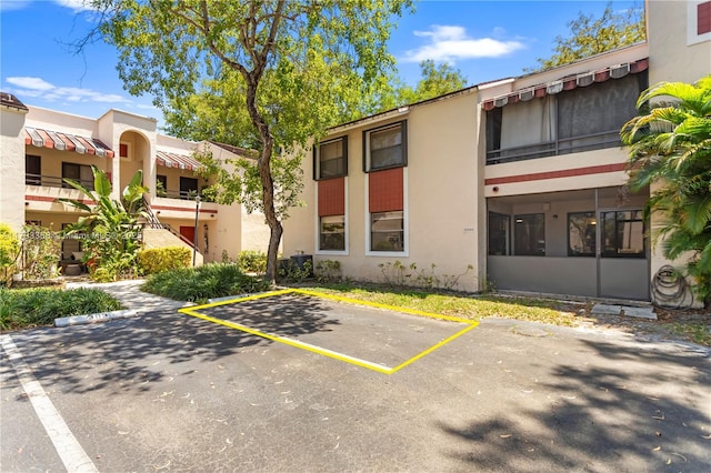 view of property with uncovered parking