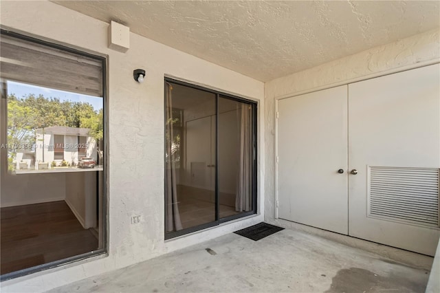 doorway to property with visible vents and stucco siding