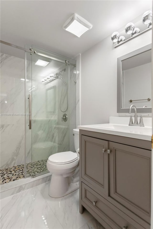 bathroom with vanity, visible vents, marble finish floor, toilet, and a marble finish shower