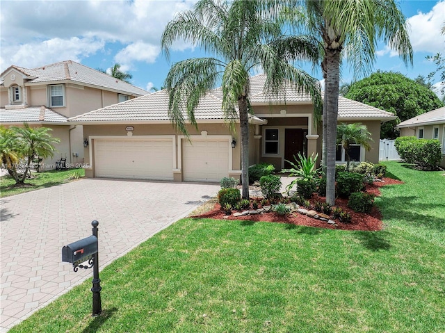 6017 NW 56th Cir, Coral Springs, FL 33067 - view of front of home with an attached garage, stucco siding, decorative driveway, and a tile roof