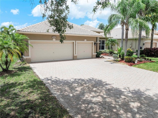 6017 NW 56th Cir, Coral Springs, FL 33067 - ranch-style house with a tile roof, decorative driveway, stucco siding, and an attached garage