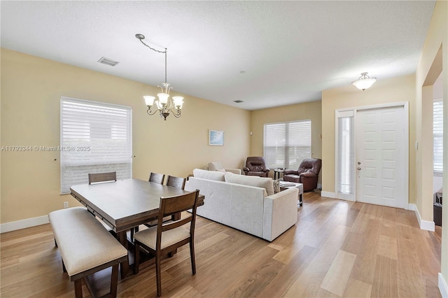 6017 NW 56th Cir, Coral Springs, FL 33067 - dining area with a chandelier and light wood-style flooring