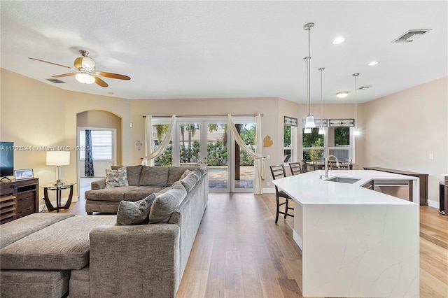 6017 NW 56th Cir, Coral Springs, FL 33067 - living area with healthy amount of natural light, a ceiling fan, light wood-type flooring, recessed lighting, and french doors