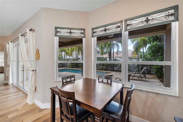 6017 NW 56th Cir, Coral Springs, FL 33067 - dining area with light wood-style floors and baseboards