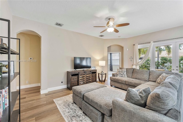 6017 NW 56th Cir, Coral Springs, FL 33067 - living area featuring arched walkways, a ceiling fan, and light wood finished floors