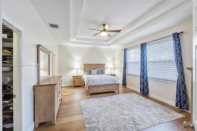 6017 NW 56th Cir, Coral Springs, FL 33067 - bedroom featuring a tray ceiling, light wood finished floors, and ceiling fan