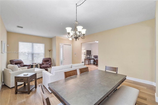 6017 NW 56th Cir, Coral Springs, FL 33067 - dining space with a chandelier and light wood-style floors