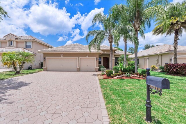 6017 NW 56th Cir, Coral Springs, FL 33067 - view of front of home featuring an attached garage, stucco siding, decorative driveway, and a front lawn