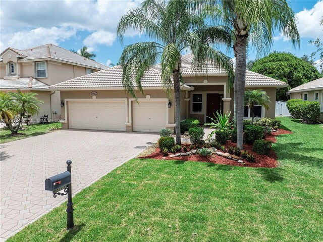 6017 NW 56th Cir, Coral Springs, FL 33067 - view of front of property featuring a garage, stucco siding, decorative driveway, and a tiled roof