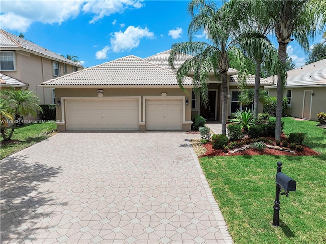 6017 NW 56th Cir, Coral Springs, FL 33067 - view of front of home featuring decorative driveway, a tile roof, an attached garage, a front yard, and stucco siding