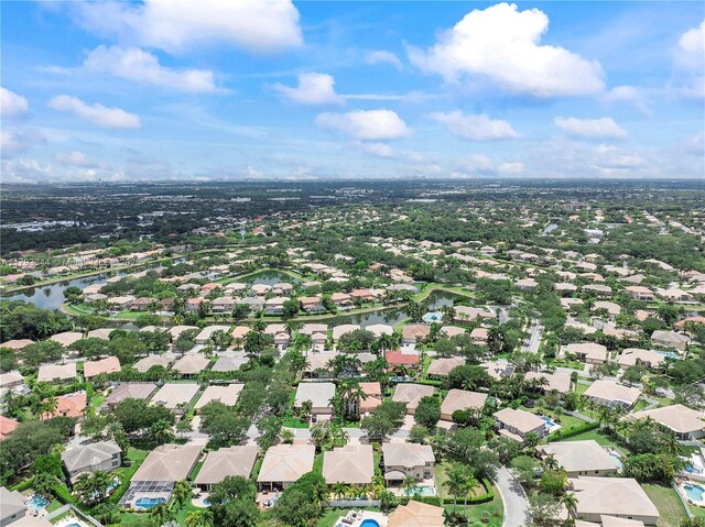 6017 NW 56th Cir, Coral Springs, FL 33067 - aerial view of property and surrounding area with nearby suburban area and a large body of water
