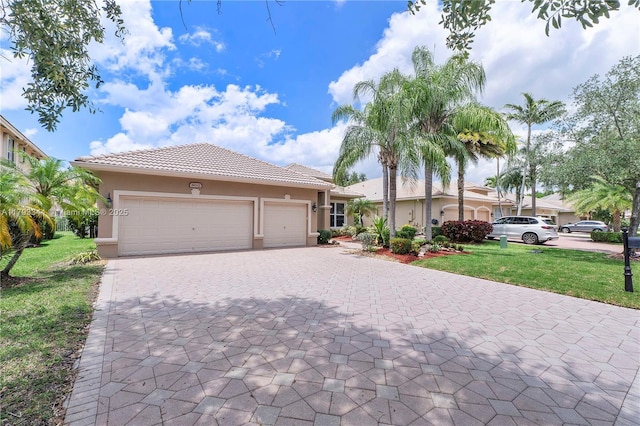 6017 NW 56th Cir, Coral Springs, FL 33067 - view of front of property featuring decorative driveway, stucco siding, a front lawn, a garage, and a tile roof