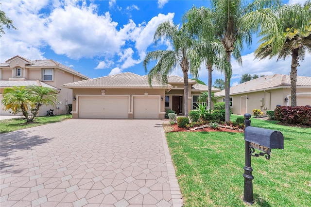 6017 NW 56th Cir, Coral Springs, FL 33067 - view of front of home with stucco siding, an attached garage, decorative driveway, and a front yard