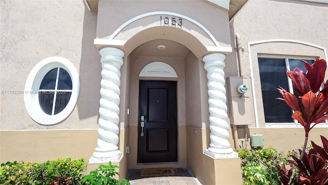 entrance to property with stucco siding