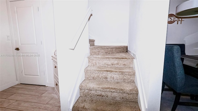 stairs featuring wood finished floors