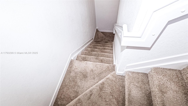 stairs with baseboards and carpet flooring