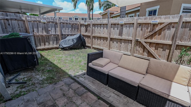 view of yard with fence, an outdoor living space, and a patio area